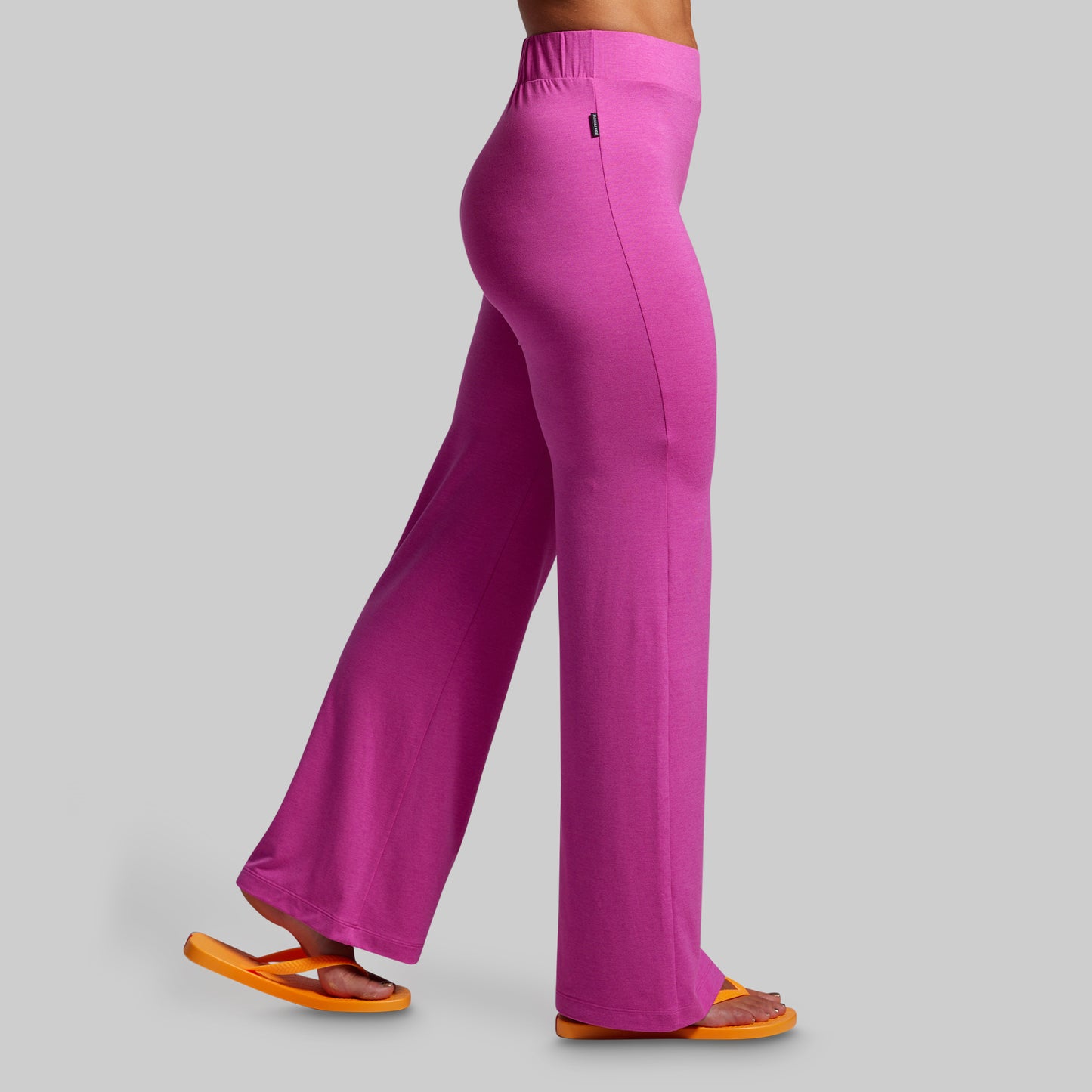 Pink pants worn by a person on a gray background