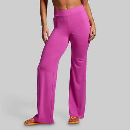 Person wearing bright pink pants on a gray background