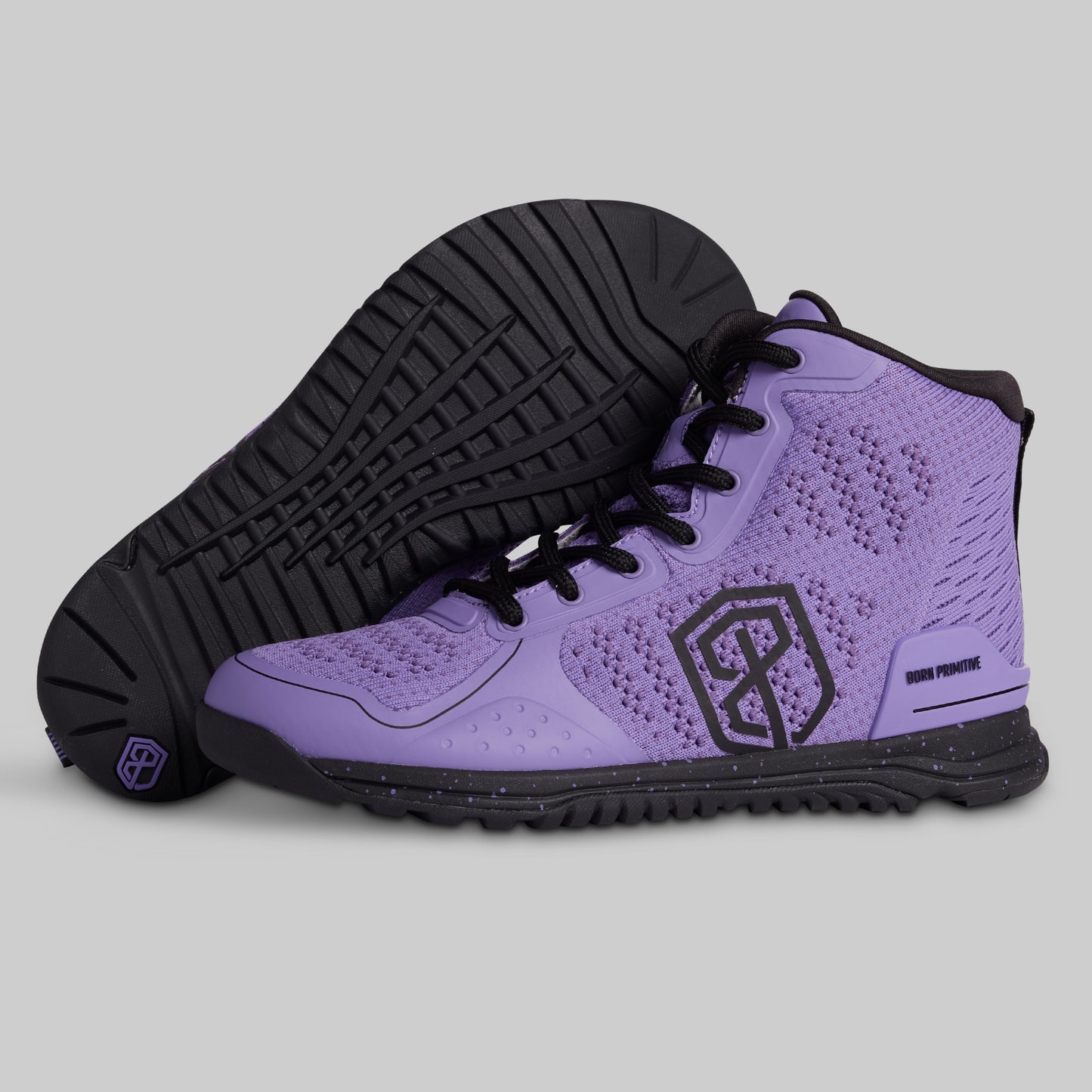 Purple high-top sneakers with black soles on a gray background
