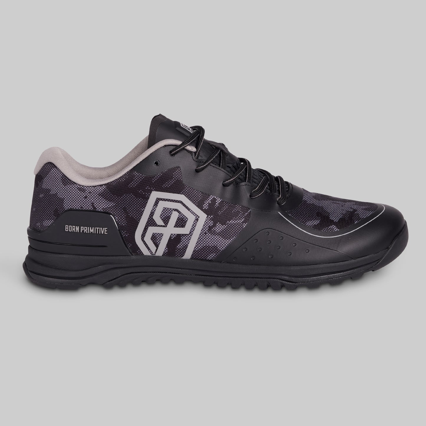 Black athletic shoe with camouflage pattern on a gray background