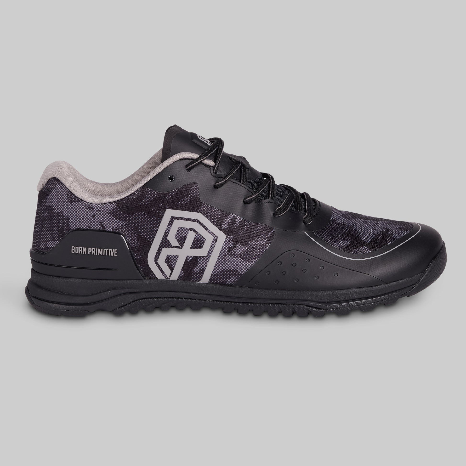 Black athletic shoe with camouflage pattern on a gray background
