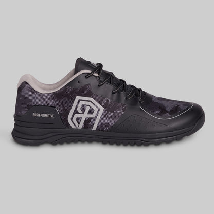 Black athletic shoe with camouflage pattern on a gray background