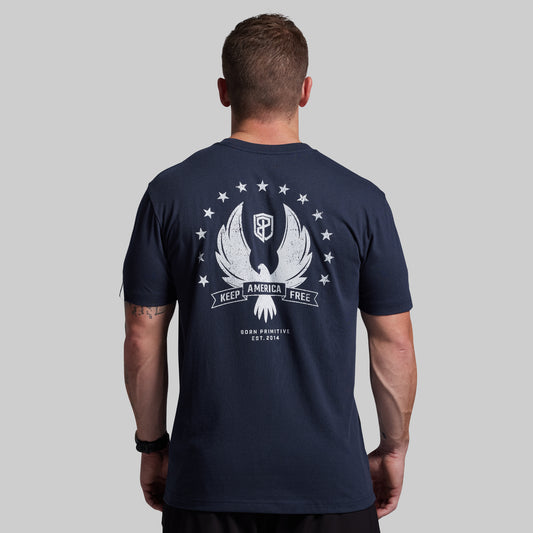 Man wearing a navy blue t-shirt with a white graphic on the back against a gray background