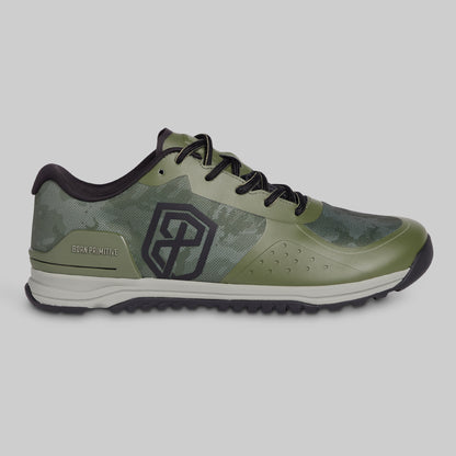 Green athletic shoe with black accents on a gray background