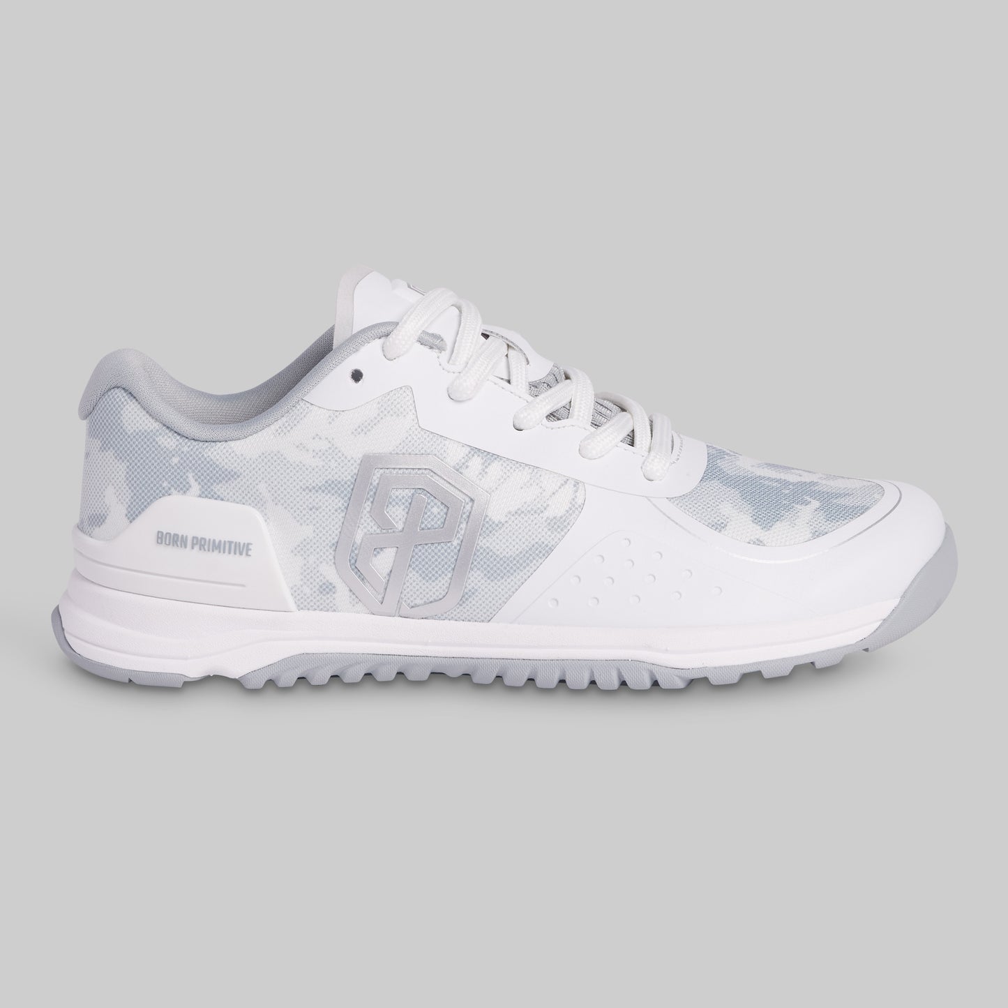White athletic shoe with a patterned sole on a gray background