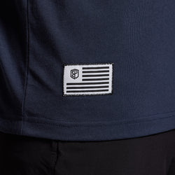 Navy blue t-shirt with a white and black patch on the bottom