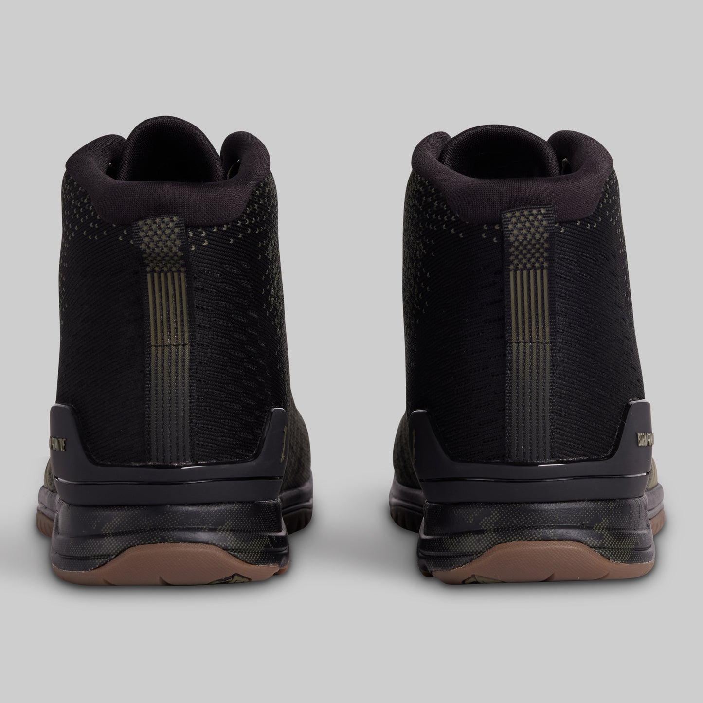 Black high-top sneakers with brown soles on a light gray background
