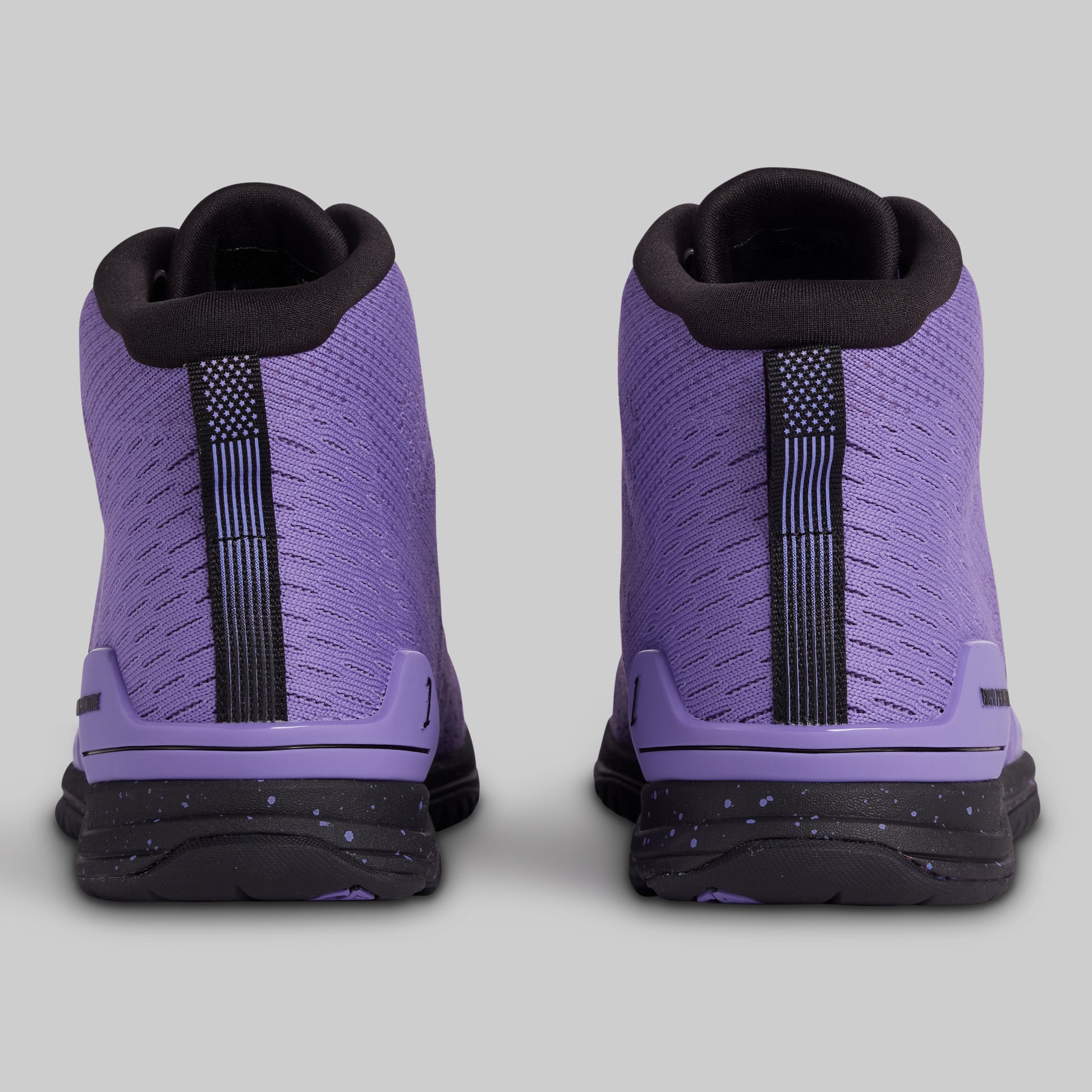 Purple high-top sneakers with black accents on a gray background