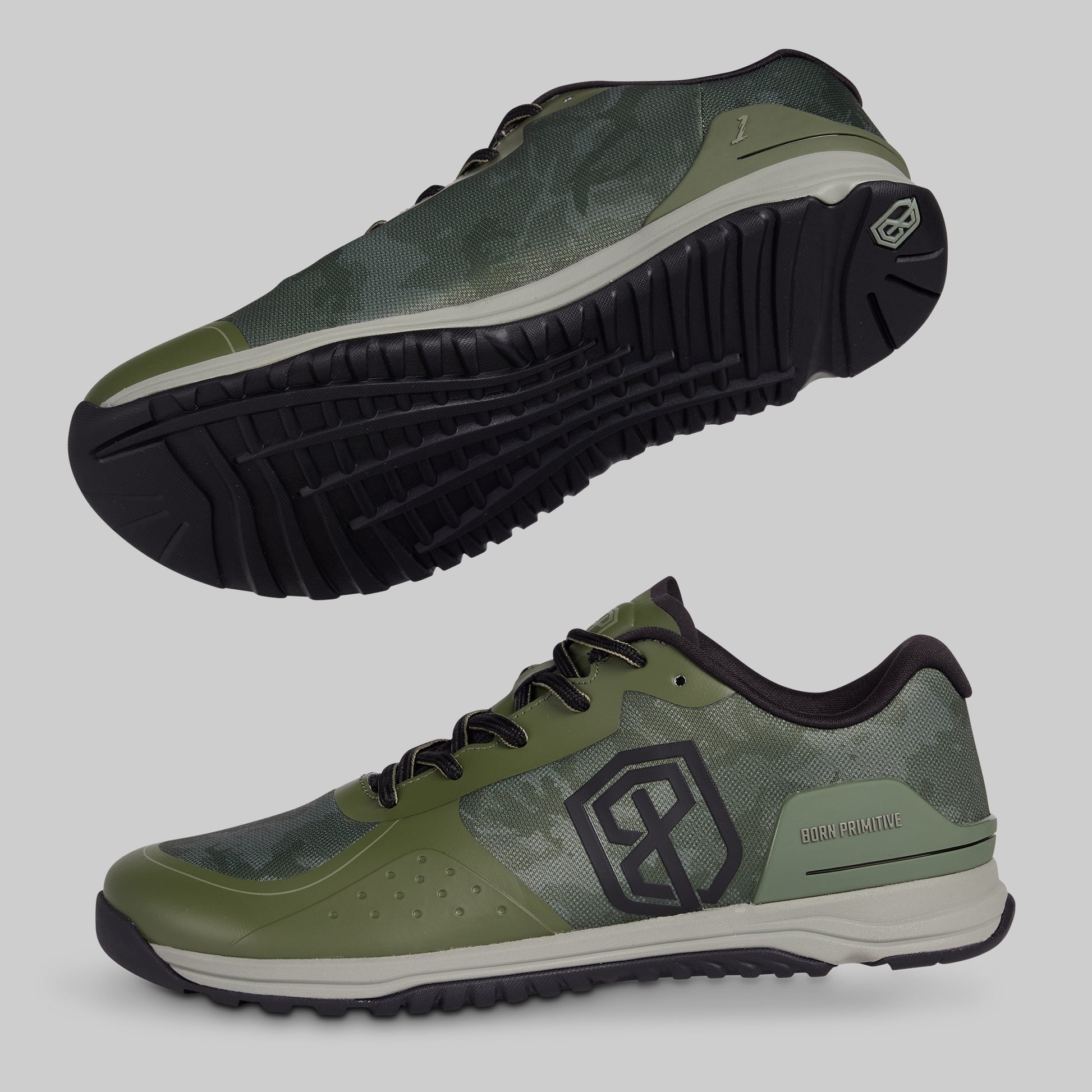 Green athletic shoes with black soles on a gray background