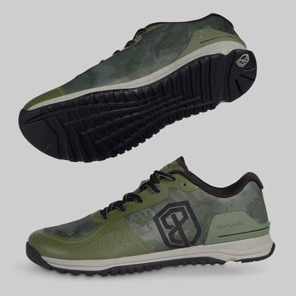 Green athletic shoes with black soles on a gray background