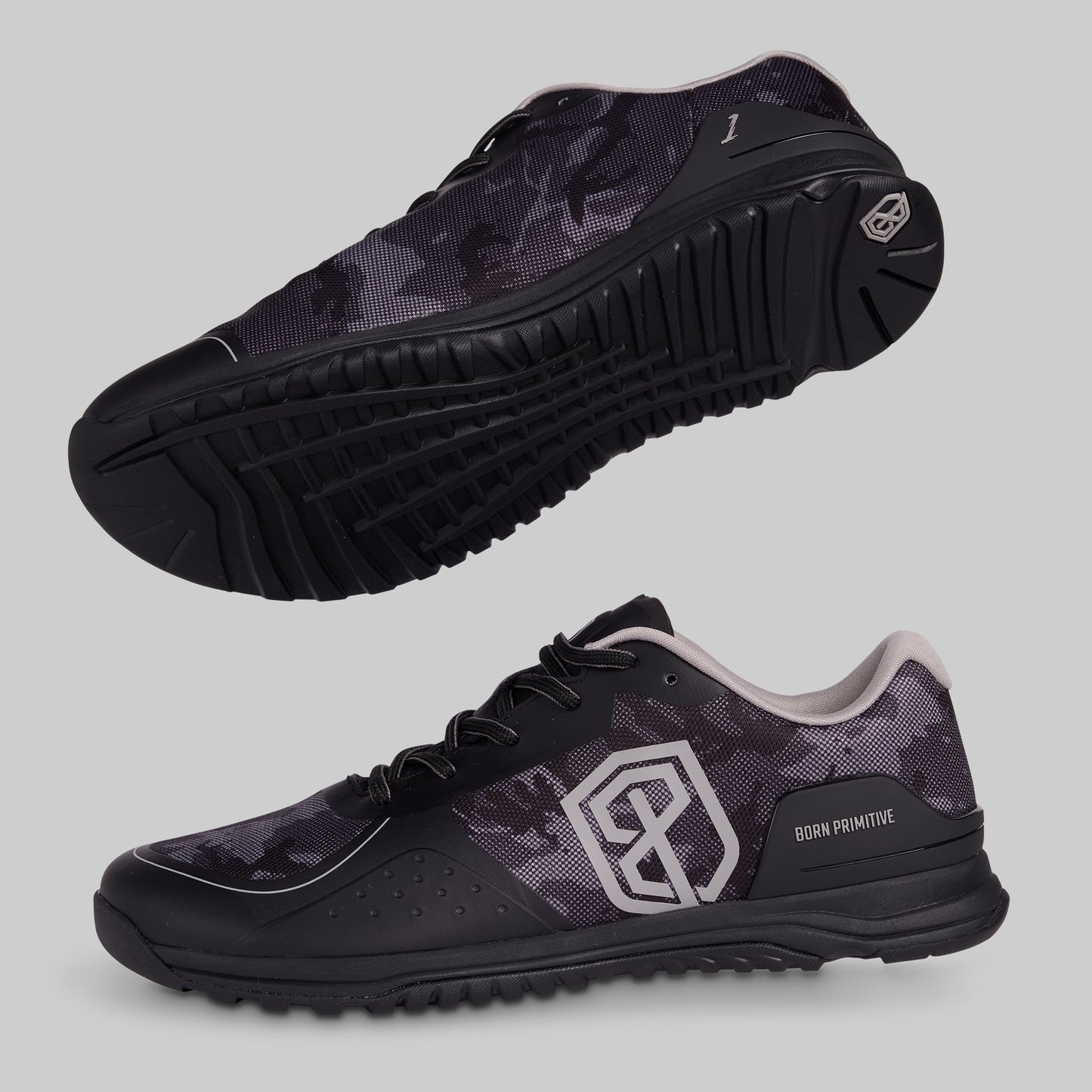 Black camo athletic shoes with a visible brand logo on a gray background