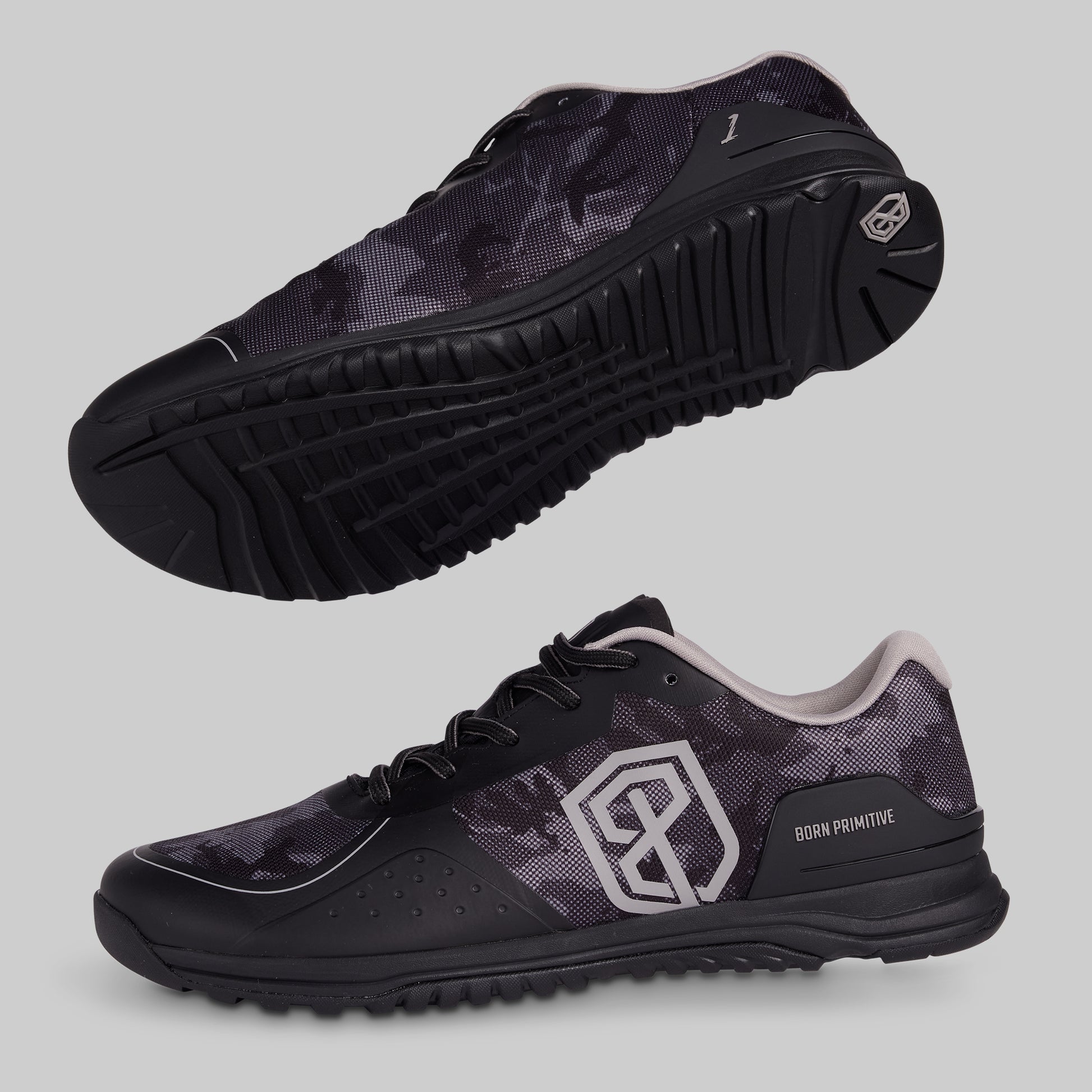 Black camo athletic shoes with a visible brand logo on a gray background