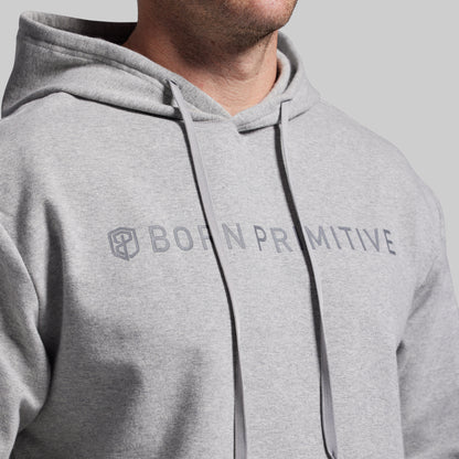 Gray hoodie with 'Born Primitive' logo on a gray background