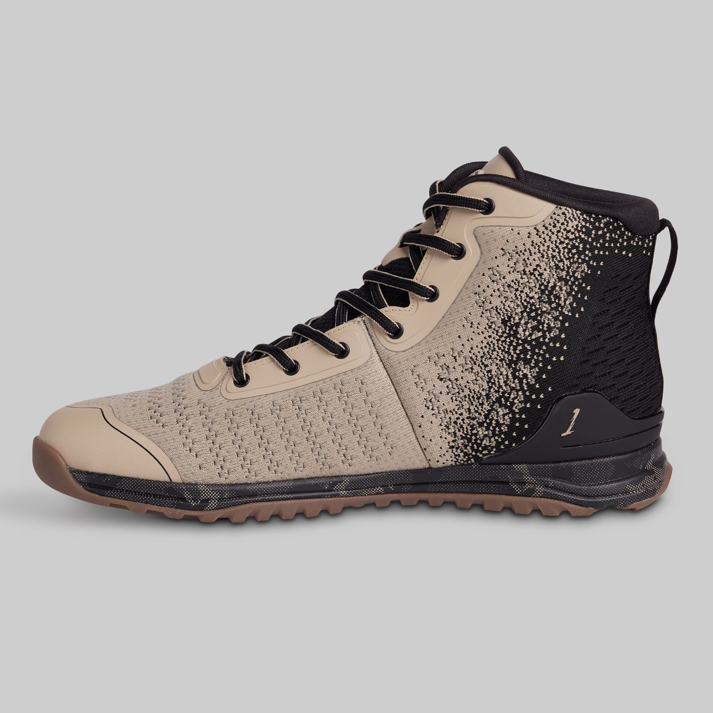 Beige and black high-top sneaker on a gray background