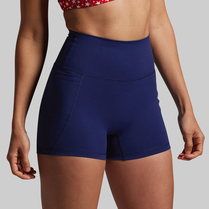 Person wearing blue athletic shorts on a plain background