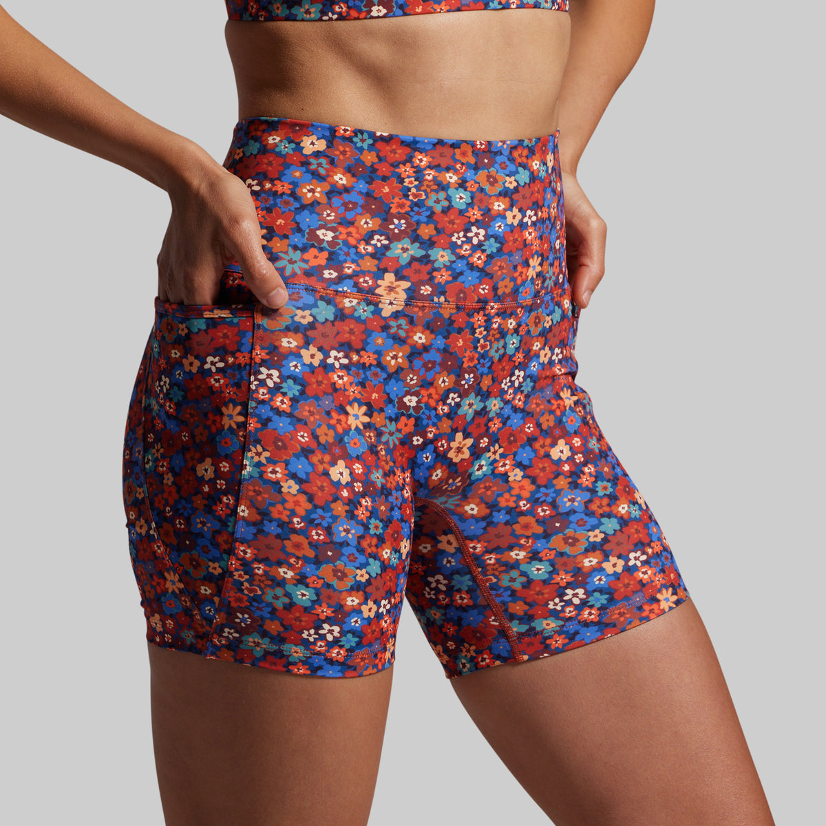 Floral patterned shorts worn by a person on a plain background