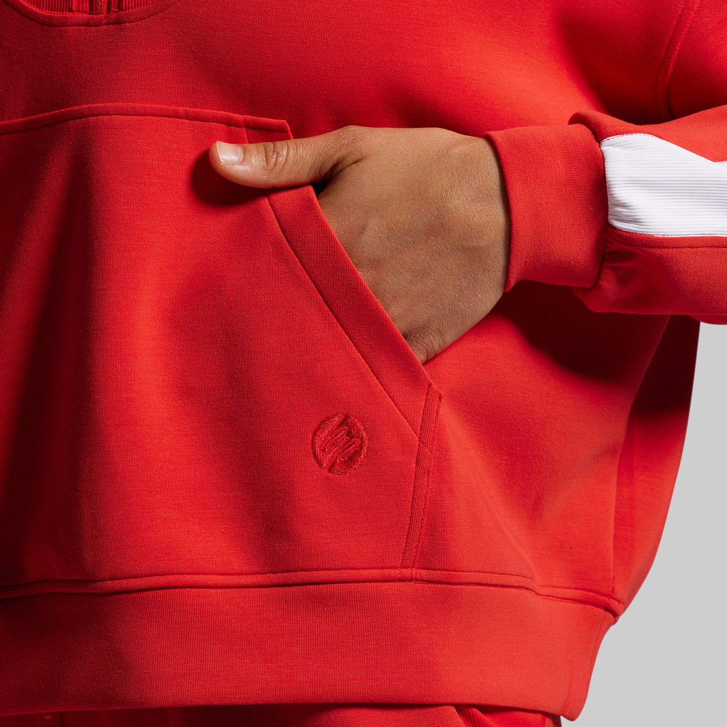 Red sweatshirt with a brand logo on a gray background