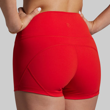 Red athletic shorts worn by a person on a gray background