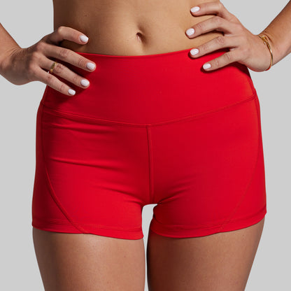 Red athletic shorts worn by a person on a gray background