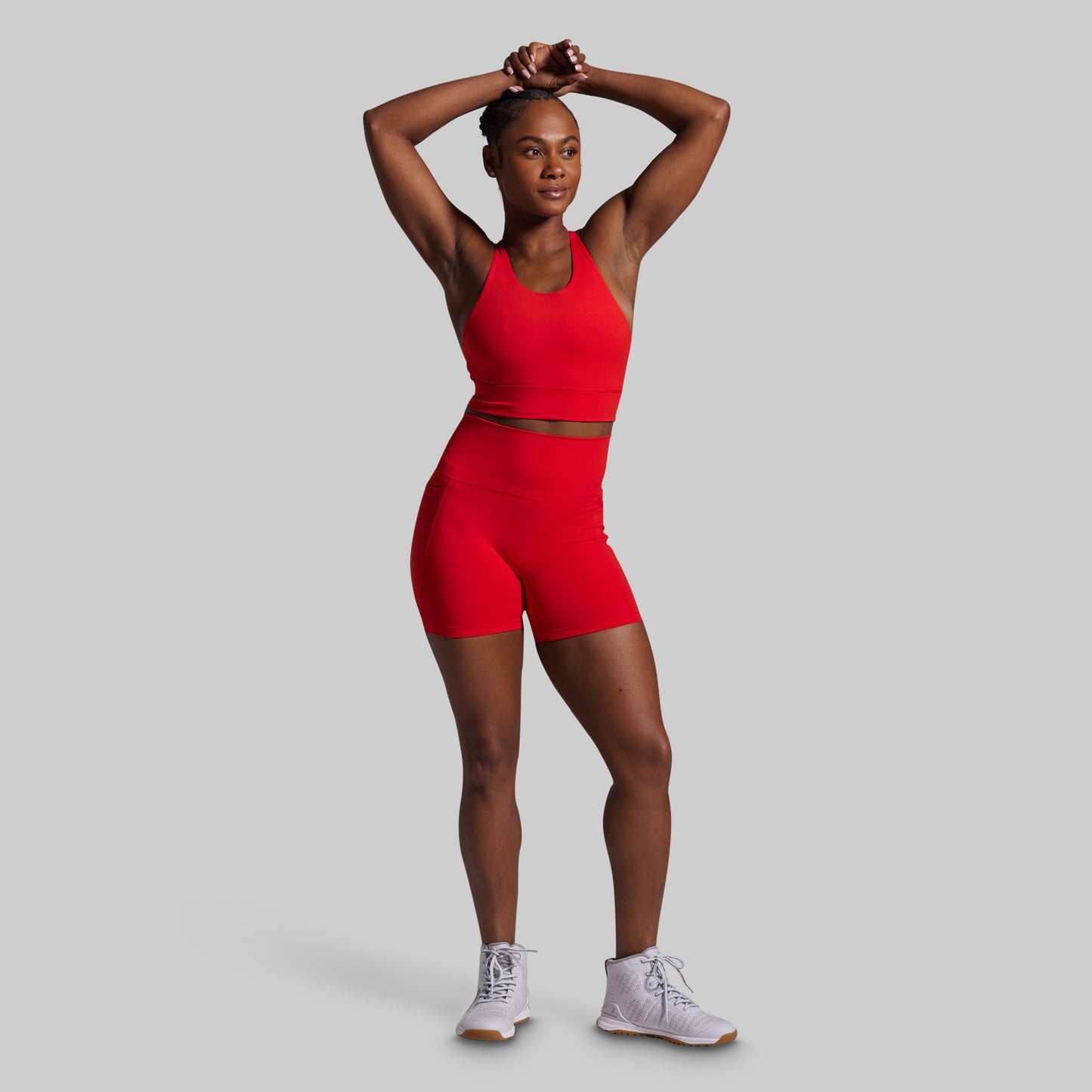 Person wearing a red athletic outfit on a gray background