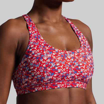 Red floral sports bra on a gray background