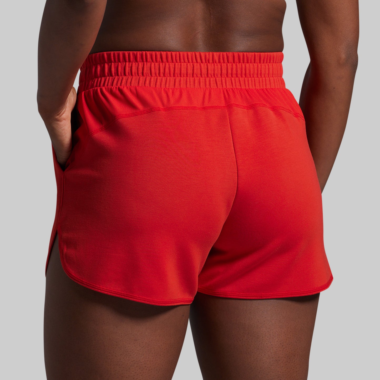 Red lounge shorts worn by a person on a gray background
