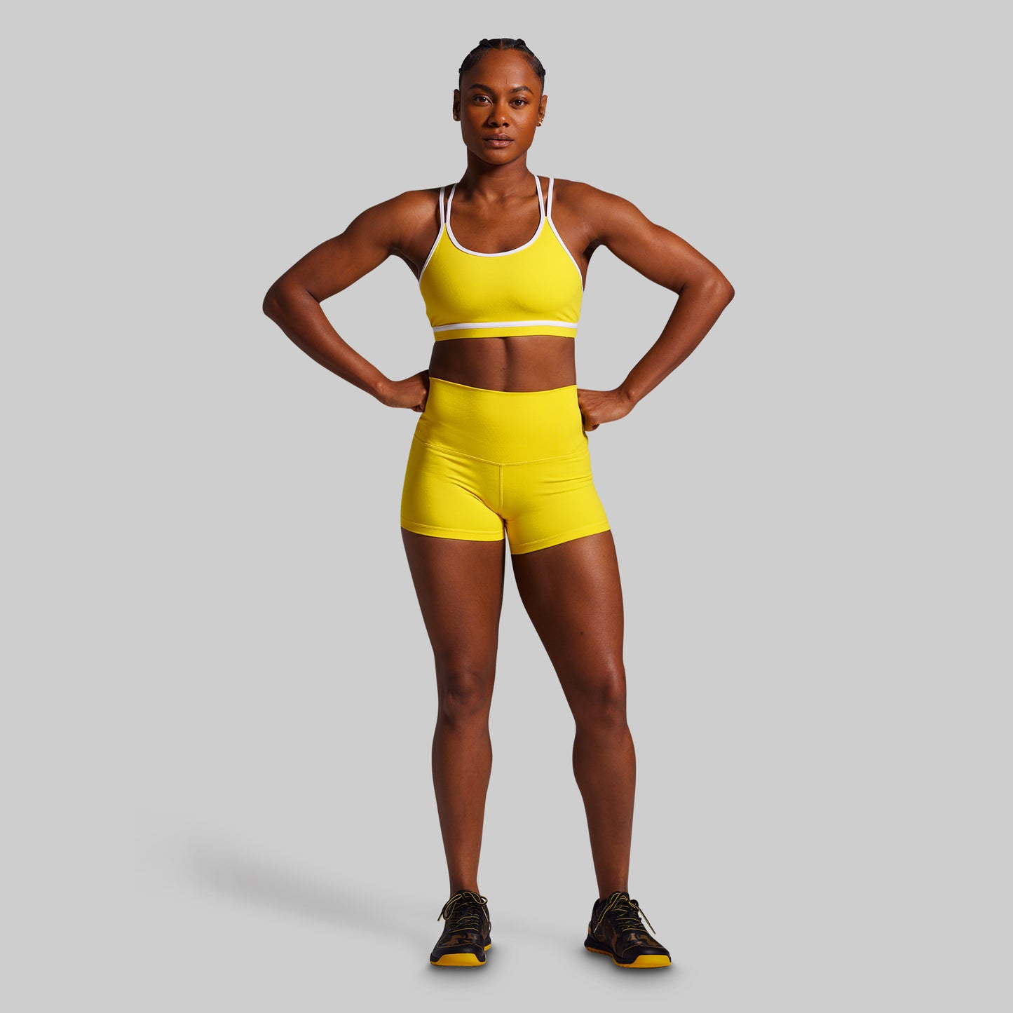 Person wearing a yellow athletic outfit on a gray background