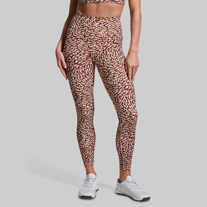 Person wearing leopard print leggings on a gray background