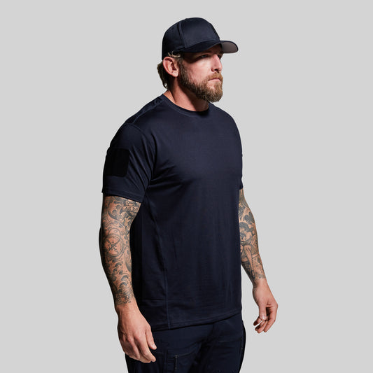 Man wearing a blue t-shirt and cap on a gray background