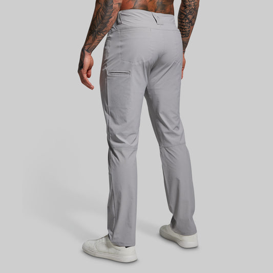 Person wearing gray pants on a plain background