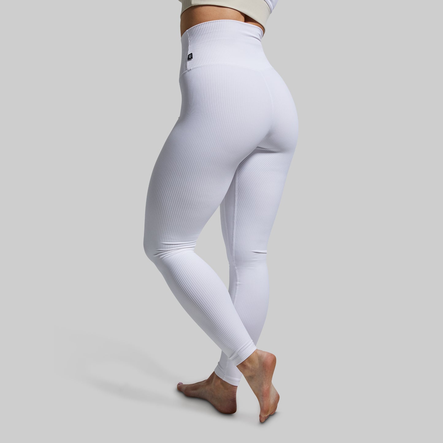White leggings worn by a person on a light gray background