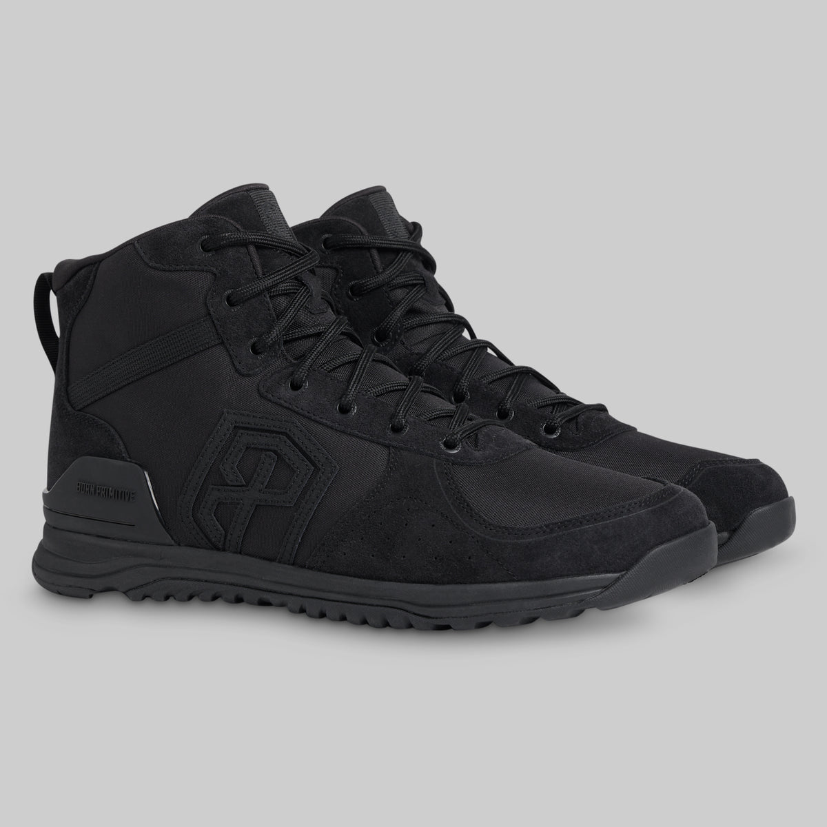 Black tactical boot on a gray background