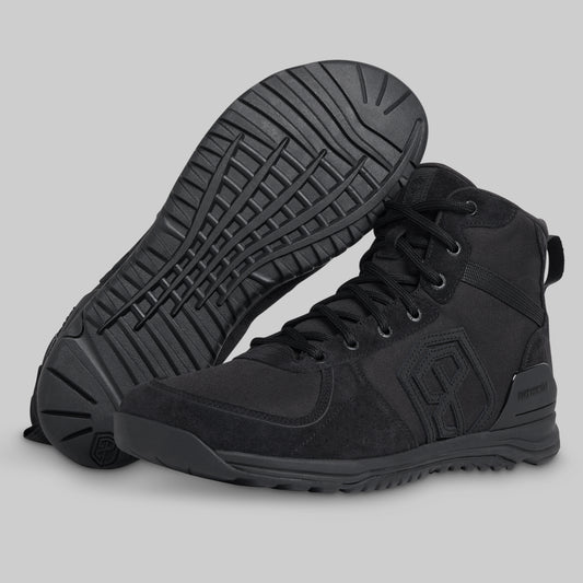 Black high-top tactical boot with a textured sole on a light gray background