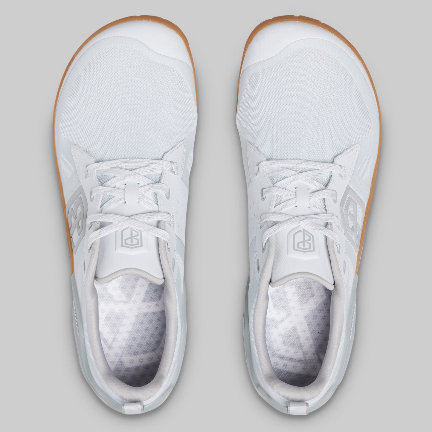 A pair of white low-top athletic sneakers shown from a top-down view on a light gray background.