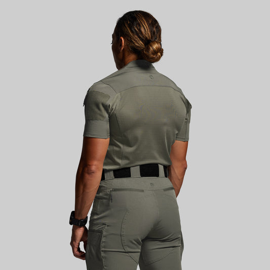 Person wearing a green uniform on a gray background