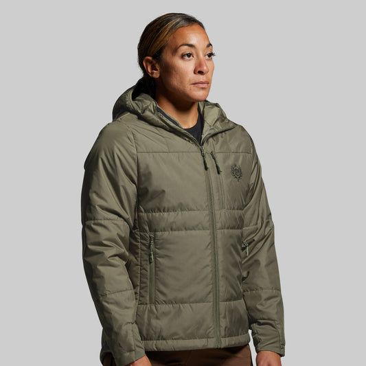 Person wearing a green puffer jacket on a gray background
