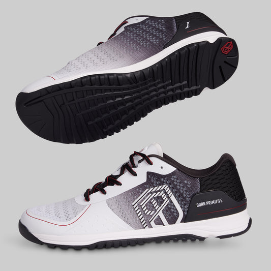 White and black athletic shoes with a visible brand logo on a gray background