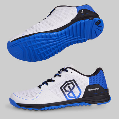 White athletic shoes with blue soles on a gray background