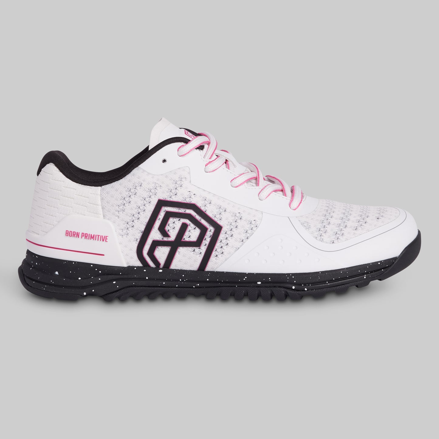 White athletic shoe with black sole and pink laces on a gray background