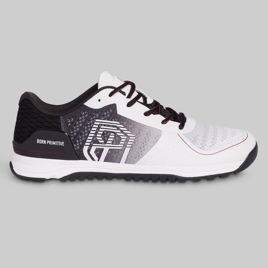 White and black athletic shoe with red accents on a gray background