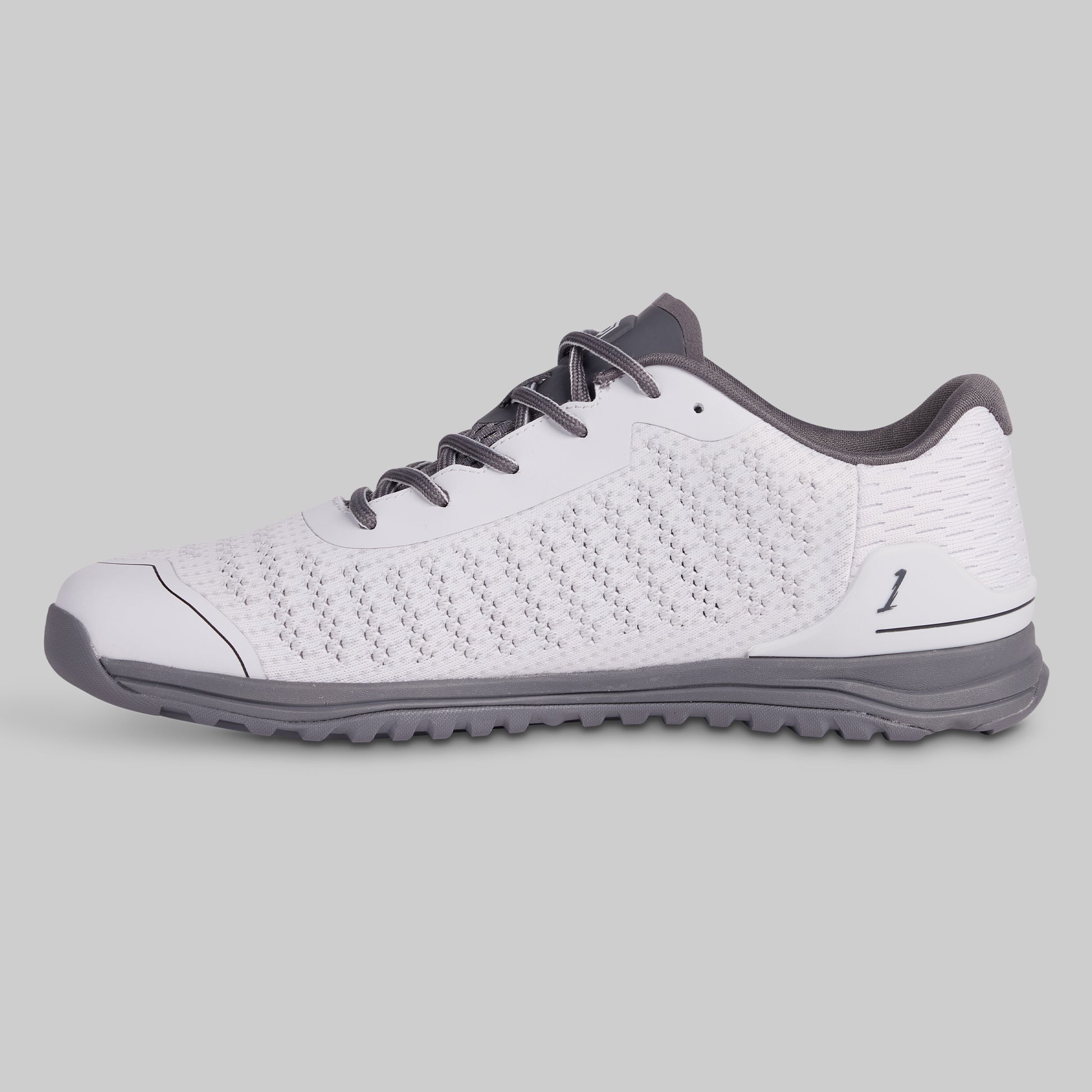 White athletic shoe with gray accents on a light gray background