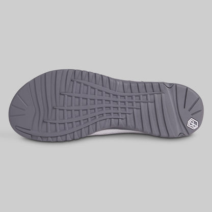 Gray shoe sole with a brand logo on a light gray background