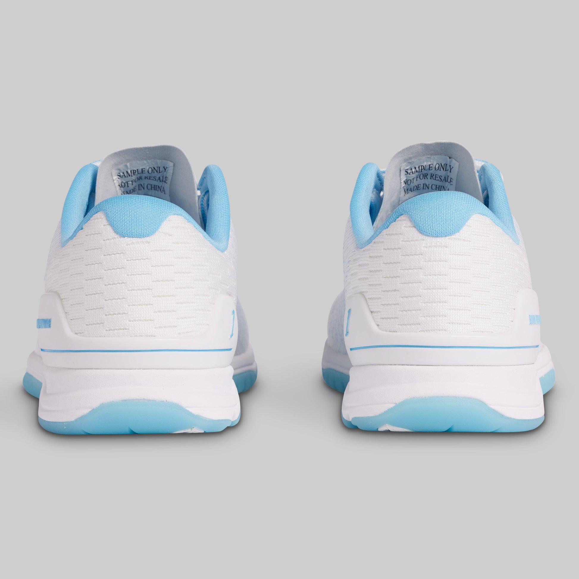 White and light blue sneakers on a gray background