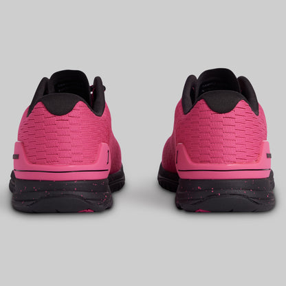 Pink and black athletic shoes shown from the back on a light gray background