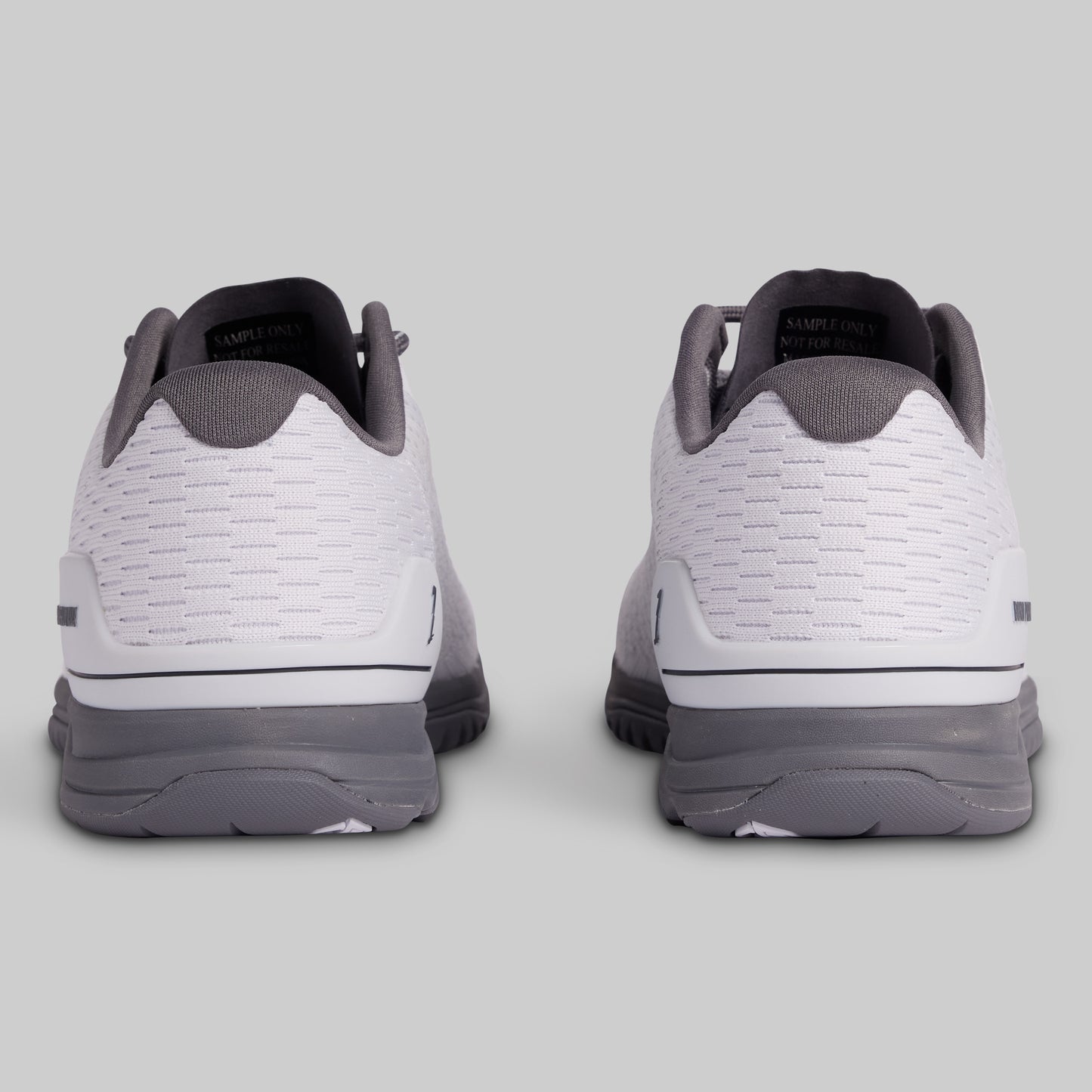 White and gray athletic shoes on a light gray background
