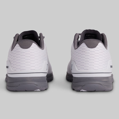 White and gray athletic shoes on a light gray background
