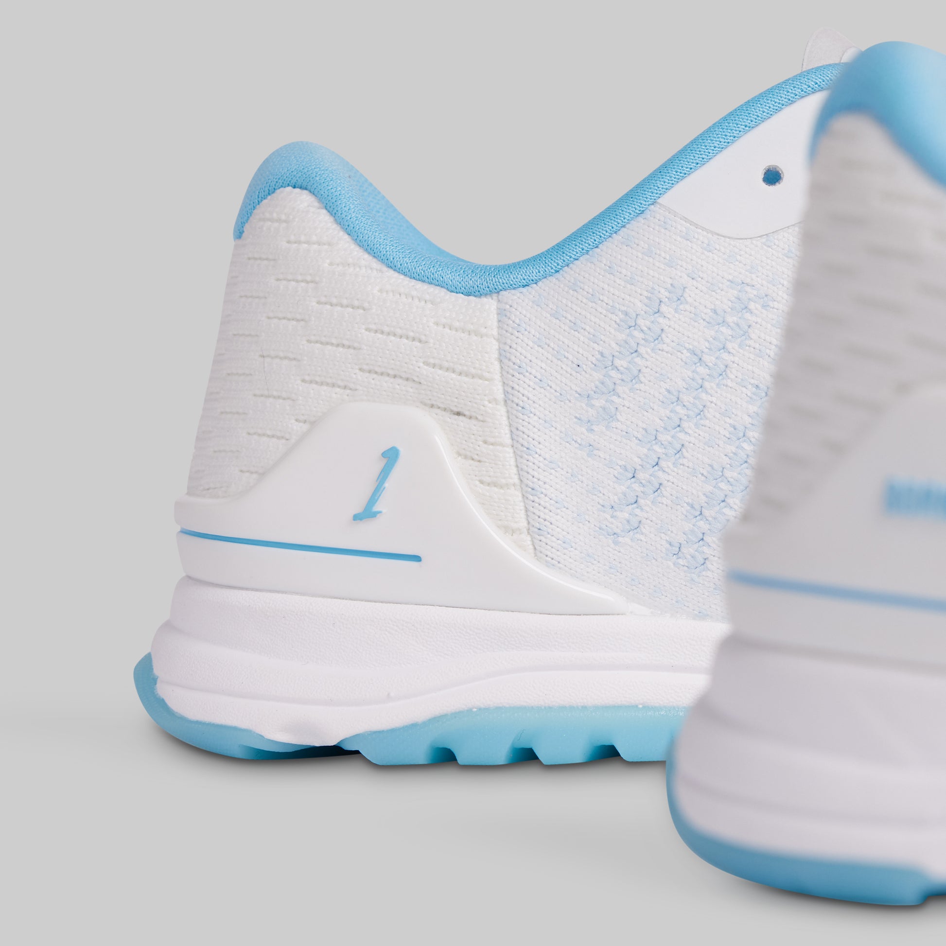 White and blue sneaker on a light gray background