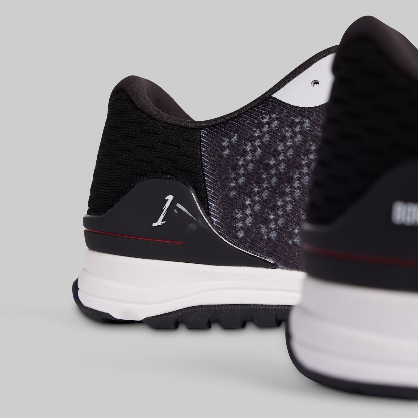 Close-up of black and white athletic shoes on a light gray background