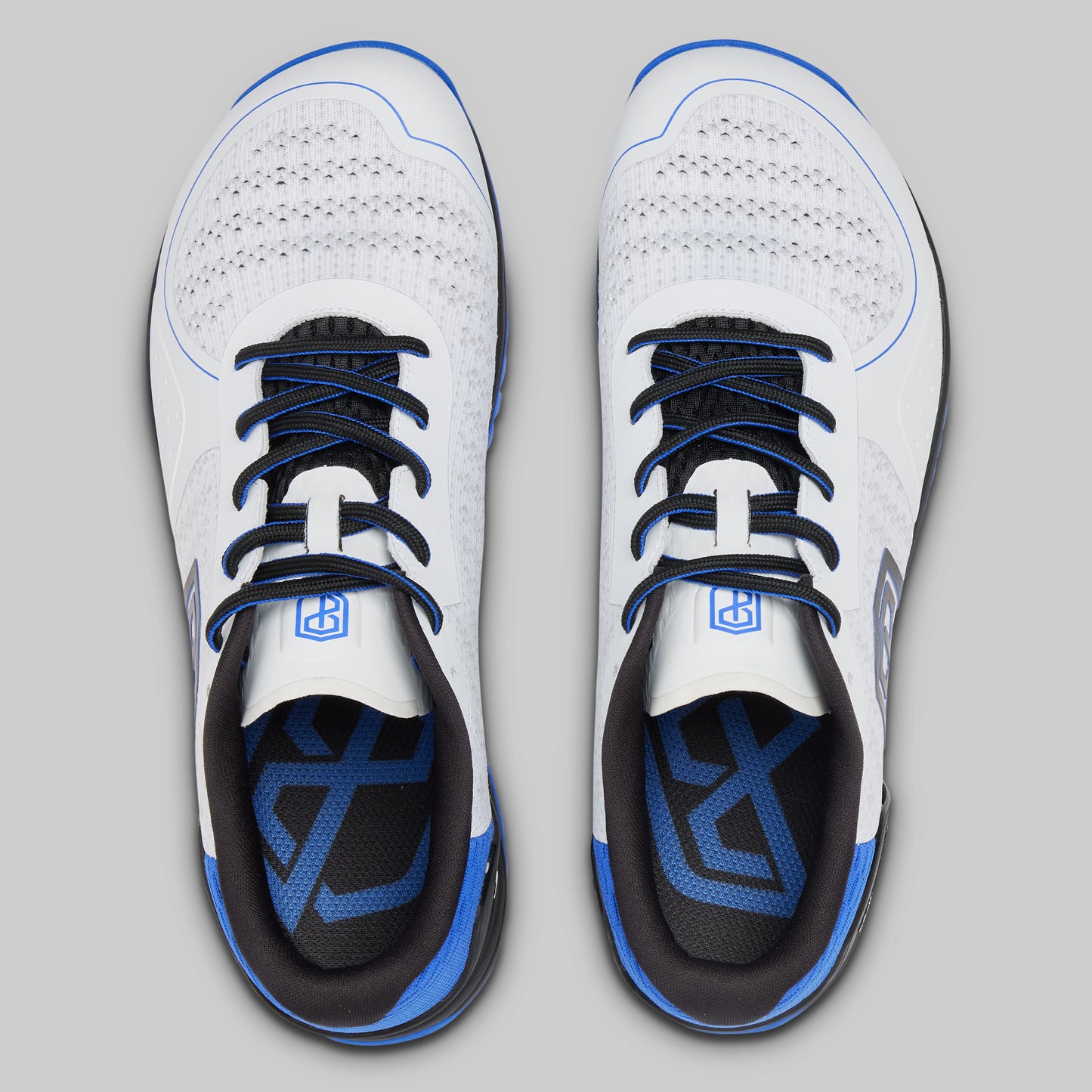 White athletic shoes with blue accents on a gray background