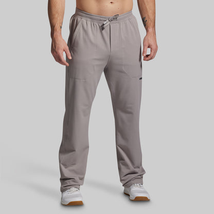 Man wearing gray pants on a plain background